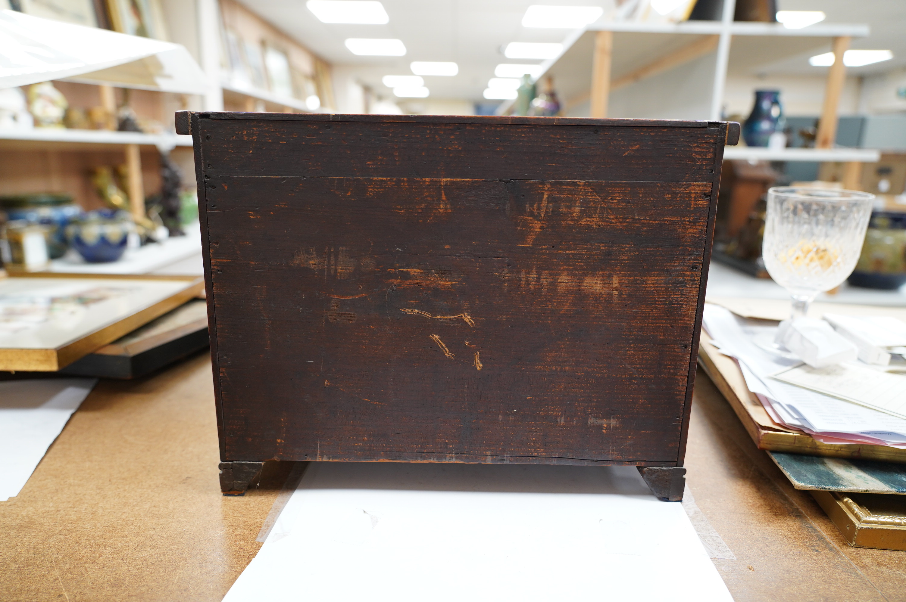 A miniature mahogany three long, two short, chest of drawers 32cms wide. Condition - good